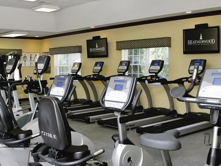 exercise bikes in a gym, tv's on the wall at Lakeside Village, East Patchogue, 11772
